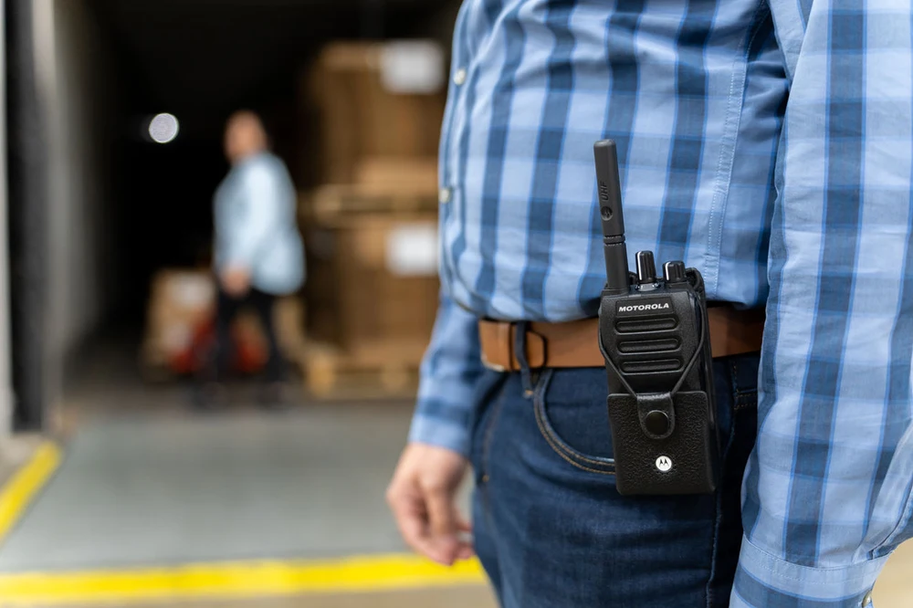 Motorola Solutions professional two-way radio in use during a logistics operation