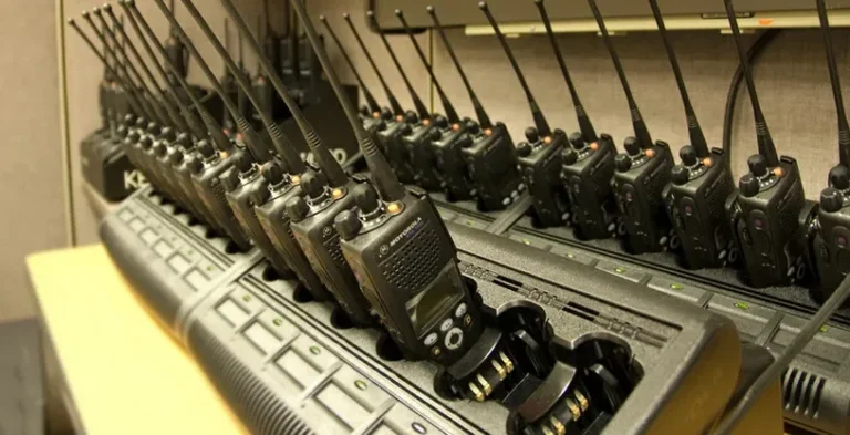 Rádios Motorola organizados em bases de recarga para preparação da operação